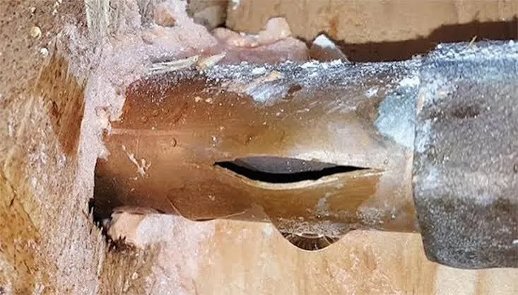 Insulated and heat-taped well water line in a Maine basement to prevent freezing